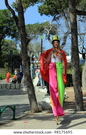 HAIFA -  MARCH 08: Woman in queen\'s costume at  Purim celebration in March 08 2012 in Gan Ha-Em in Haifa, Israel. The annual festival features entertainment, artisans and community groups.
