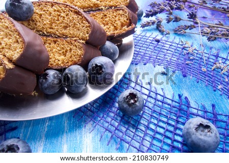 Blueberries and chocolate with lavender and spoon on wooden board