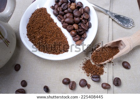 Closeup of coffee beans and roasted coffee heap. Arabic roasting coffee - ingredient of hot beverage.