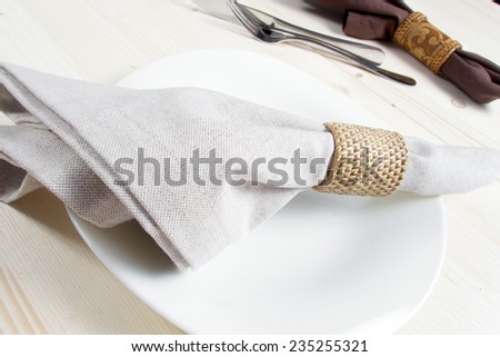 Fork, knife, napkin and empty pate on the dinner table