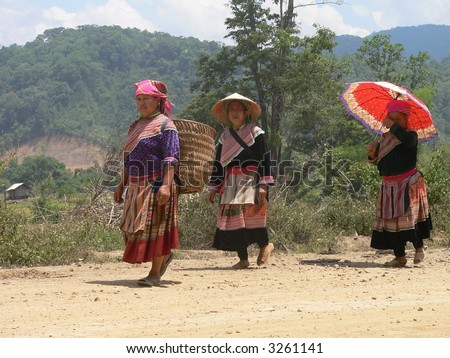 Three H\'mong migrants coming home from the market in Central Highland of Vietnam. They are native to the Northern Mountains but have relocated to the Highland to find new homes.