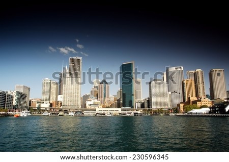Stock Photo of Sydney CBD from Sydney Harbour featuring the city, circular quays, the rocks, ferry and waterfront skyline. Modern and heavily polarised.