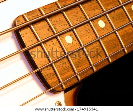 A bass guitar fret board macro closeup for background or wallpaper.