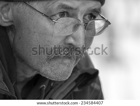 Black and white portrait of an Elderly Man looking concerned about life.