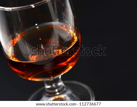 Alcohol drink, glass on black background