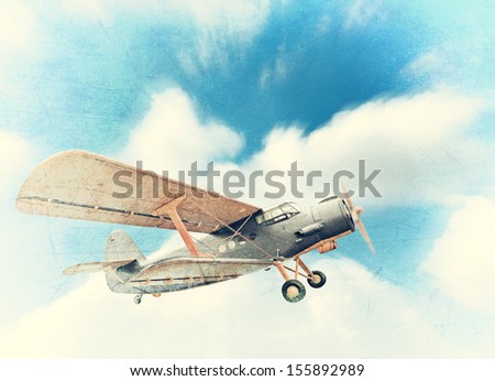 Old biplane in the sky, vintage background