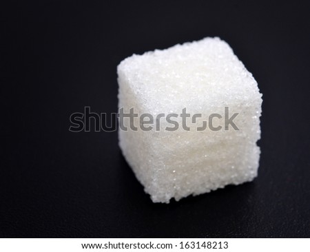 Piece of sugar on black background
