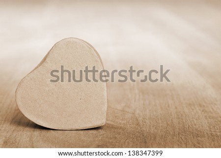 heart shaped box on wooden table, sepia toned