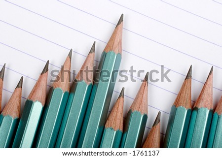 new sharp pencils on a lined paper background