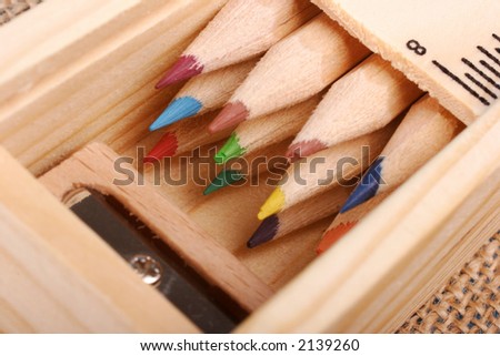 colored pencils in a wooden pencil case