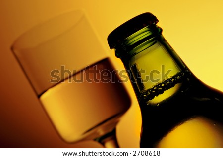 bottle and glass of alcohol with golden ambient light