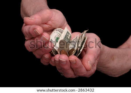 elderly ladies hands outstretched with money.