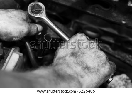 mechanic at work, repairing an engine
