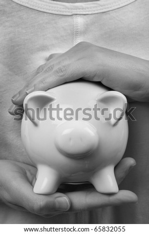protecting your finances, secure hands around a money box