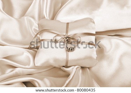 stock photo wedding and diamond engagement rings on silk presentation 