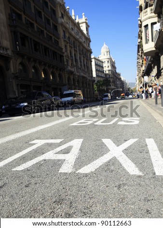 Traffic signs Taxi and Bus , low angle view of street with painted sign demarcating lanes