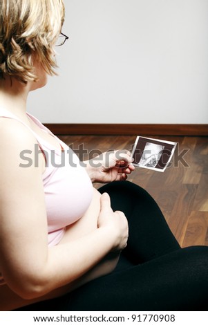 Pregnant woman looking at ultrasound image