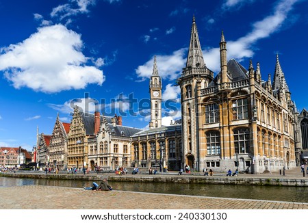 GENT, BELGIUM - 11 AUGUST 2014: Image of medieval Graslei with tourists, houses facades and water canal in Ghent, heritage of Flanders, Belgium.