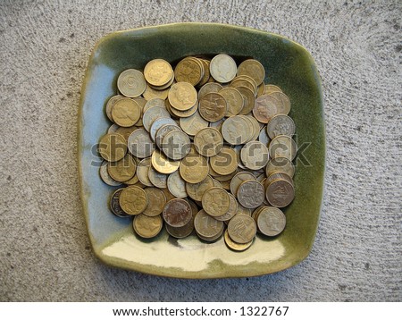 A plateful of one dollar Australian coins.