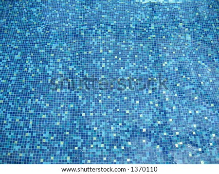 Blue abstract pattern created by gentle waves of a swimming pool.