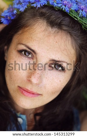 Beautiful Girl With Flowers.Beauty Model Woman Face with freckles.
