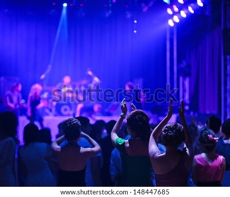 concert, happy people silhouettes, raise up hands, disco party with large group of dancing man, bright colorful stage lights, active lifestyle, music entertainment, nightclub, night life concept