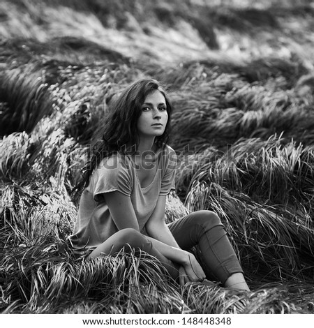 Beautiful girl relaxing in the field. Beauty Model Woman Face with freckles.