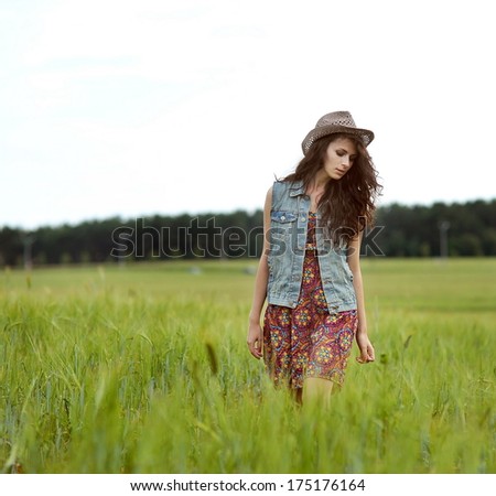 Beautiful Girl in the field. Beauty Model Woman Face with freckles.