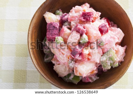Haitian potato salad, salad pomdete, in small wooden bowl seen from directly above