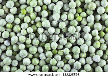 Fresh green peas covered with water drops, food background.