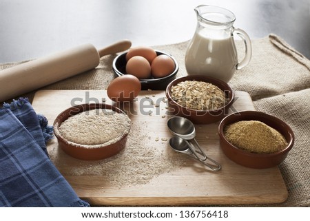 Ingredients for whole grain healthy bread, whole wheat flour, rolled oats and wheat germ with milk and eggs.