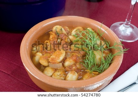 Lima bean stew with dill in earthenware bowl.