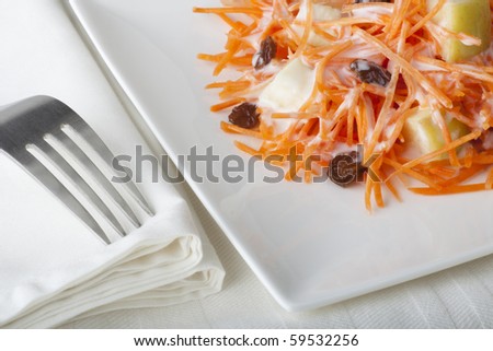 Fresh carrot salad with shredded carrots, raisins, apples and a light curry yogurt dressing.