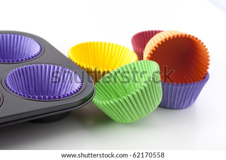 Colorful cupcake papers and muffin pan ready for baking.