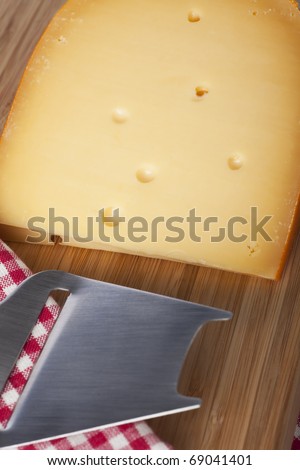 Dutch cheese block with metal cheese slicer.