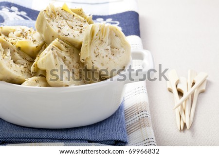 Artichoke hearts covered in herbs served as an appetizer