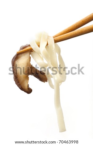 Shitake mushroom and flat asian noodles held by chop sticks and isolated on white background.