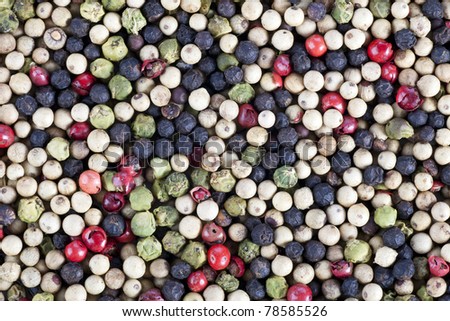 Mixture of white green red and black peppercorns as a food background or texture