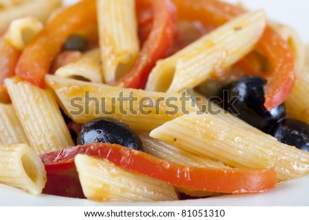 Penne pasta dinner with red bell peppers and black olives