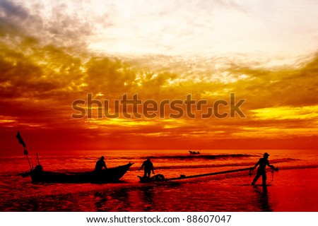 silhouette fisherman at work on great sunset