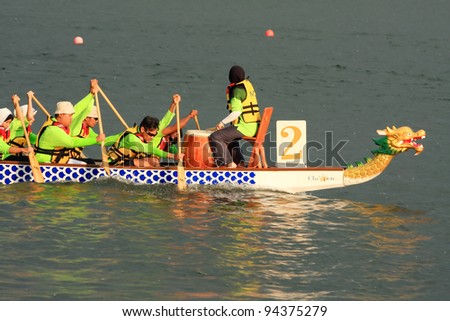 PUTRAJAYA, MALAYSIA - OCTOBER 21: Unidentified teams participate in IDBF Cancer Survivors World Cup 2011 & Malaysia International Dragon Boat Festival 2011 in Putrajaya, Malaysia on October 21, 2011.