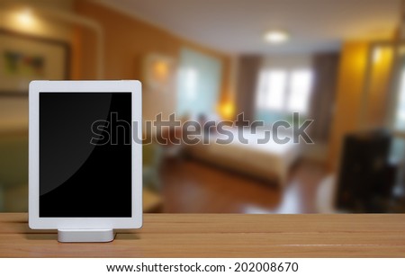 tablet pc computer with dock station on blur bedroom background.