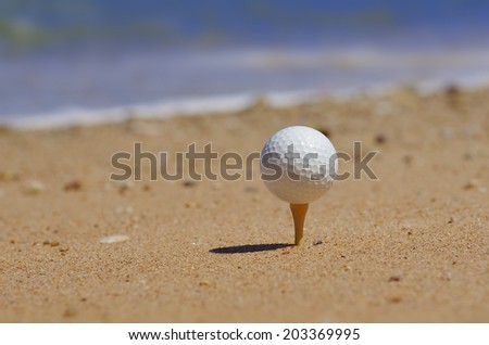 golf ball tee off on the beach.