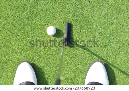 Golfer on training putt golf ball