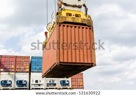 Industrial port crane loading import and export Containers box in a Cargo container ship.