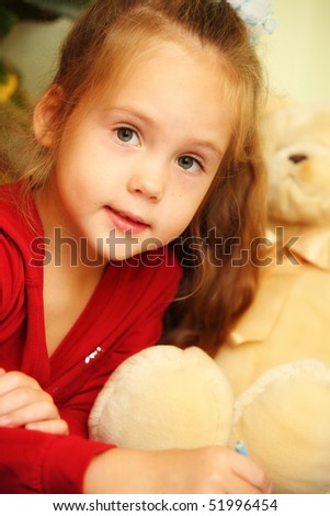 closeup of a pretty little girl with teddy bear drawing