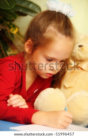 closeup of a pretty little girl with teddy bear drawing