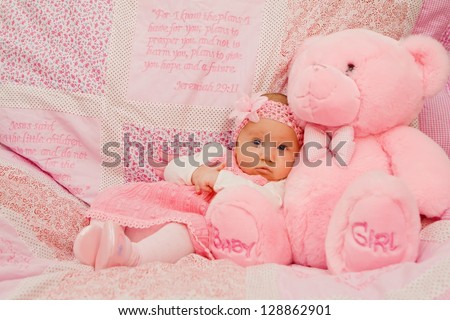 Baby girl on pink blanket with Bible verses