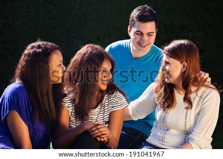 Young adult interracial group of friends talking and laughing