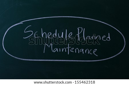 Schedule planned maintenance written with chalk on chalkboard